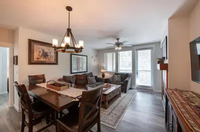 a dining room and living room with a table at Deluxe Fraser Crossing Founders Pointe Condo with Ski Storage and washer dryer condo in Winter Park
