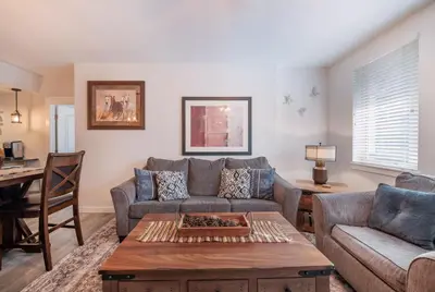 a living room with a couch and a table at Deluxe Fraser Crossing Founders Pointe Condo with Ski Storage and washer dryer condo in Winter Park