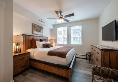 a bedroom with a bed and a ceiling fan at Deluxe Fraser Crossing Founders Pointe Condo with Ski Storage and washer dryer condo in Winter Park