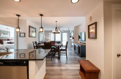 a kitchen and living room with a dining room at Deluxe Fraser Crossing Founders Pointe Condo with Ski Storage and washer dryer condo in Winter Park