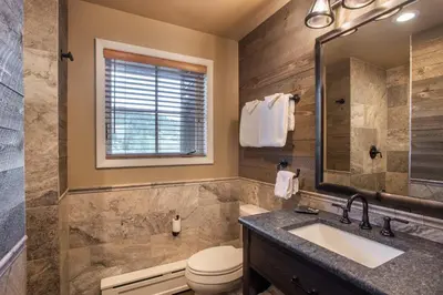 a bathroom with a sink and a toilet at Stunning Zephyr Mountain Lodge Condo Overlooking The Village Plaza condo in Winter Park