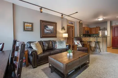 a living room with a couch and a table at Lovely Zephyr Mountain Lodge Condo with Mountain Slope Views condo in Winter Park