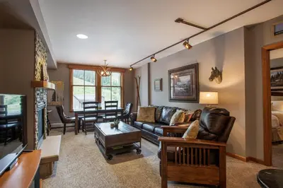 a living room with a couch and a table at Lovely Zephyr Mountain Lodge Condo with Mountain Slope Views condo in Winter Park