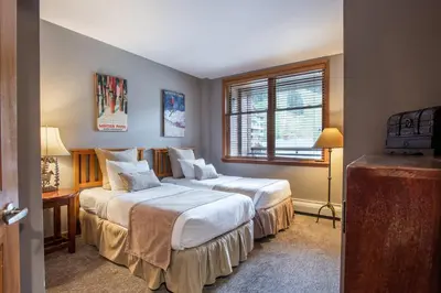 a bedroom with two beds and a window at Lovely Zephyr Mountain Lodge Condo with Mountain Slope Views condo in Winter Park