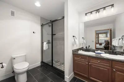 a bathroom with two sinks and a shower at Lovely Zephyr Mountain Lodge condo with Continental Divide and Village Views condo in Winter Park