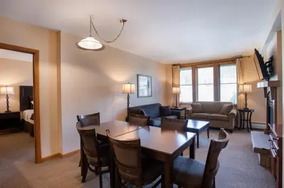 a living room with a dining table and a living room at Lovely Zephyr Mountain Lodge condo with Continental Divide and Village Views condo in Winter Park