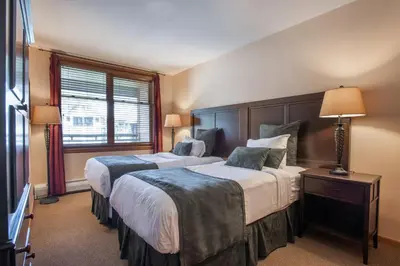 a hotel room with two beds and a window at Lovely Zephyr Mountain Lodge condo with Continental Divide and Village Views condo in Winter Park