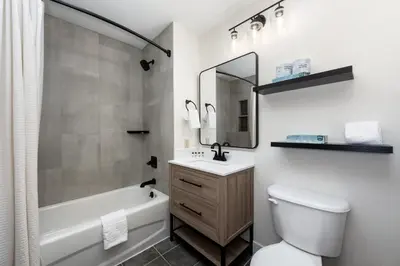 a bathroom with a tub and a toilet and a sink at Lovely Zephyr Mountain Lodge condo with Continental Divide and Village Views condo in Winter Park