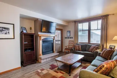 a living room with a couch and a fireplace at Terrific Zephyr Mountain Lodge Condo With Beautiful Views of the Continental Divide near Mountain condo in Winter Park