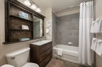 a bathroom with a toilet and a tub and a sink at Terrific Zephyr Mountain Lodge Condo With Beautiful Views of the Continental Divide near Mountain condo in Winter Park