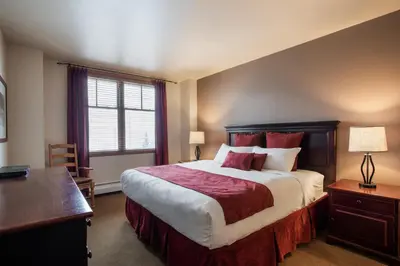 a bedroom with a large bed and a desk at Terrific Zephyr Mountain Lodge Condo With Beautiful Views of the Continental Divide near Mountain condo in Winter Park