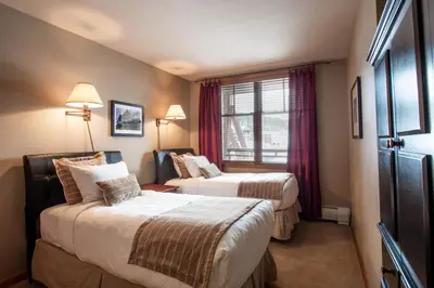 a hotel room with two beds and a window at Large Zephyr Mountain Lodge condo with fireplace and Village Views condo in Winter Park