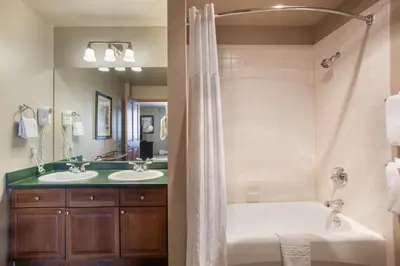 a bathroom with two sinks and a tub and a shower at Large Zephyr Mountain Lodge condo with fireplace and Village Views condo in Winter Park