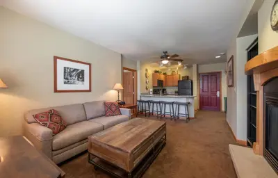 a living room with a couch and a table at Large Zephyr Mountain Lodge condo with fireplace and Village Views condo in Winter Park