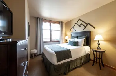 a hotel room with a bed and a television at Great Zephyr Mountain Lodge Condo with Village & Continental Divide Views condo in Winter Park