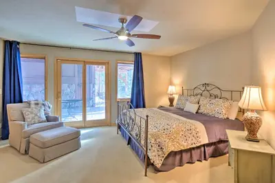 a bedroom with a bed and a ceiling fan at Grand Fraser Escape with Private Deck and Hot Tub in Fraser