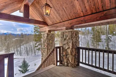 a balcony with a view of the snow covered trees at Grand Fraser Escape with Private Deck and Hot Tub in Fraser