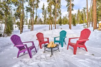 four chairs and a table in the snow at Grand Fraser Escape with Private Deck and Hot Tub in Fraser