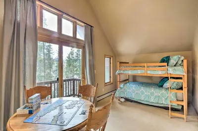 a bedroom with a bunk bed and a table at Grand Fraser Escape with Private Deck and Hot Tub in Fraser