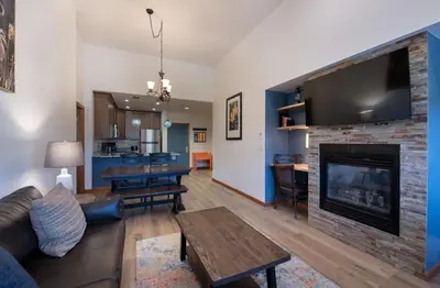 a living room with a couch and a fireplace at Zephyr Mountain Lodge - Premium Rated Condo 1701 in Winter Park