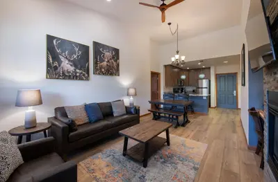 a living room with a couch and a table at Zephyr Mountain Lodge - Premium Rated Condo 1701 in Winter Park