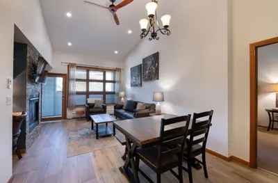 a dining room and living room with a table and chairs at Zephyr Mountain Lodge - Premium Rated Condo 1701 in Winter Park