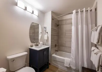 a bathroom with a sink and a toilet and a tub at Zephyr Mountain Lodge - Premium Rated Condo 1701 in Winter Park