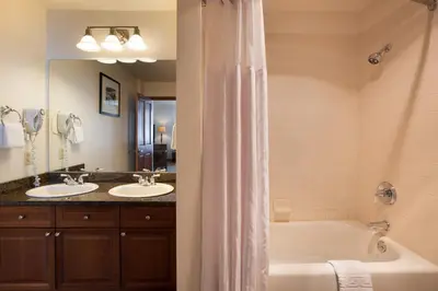 a bathroom with two sinks and a bath tub at Upgraded Zephyr Mountain Lodge Condo with Continental Divide Views Close to Mountain condo in Winter Park