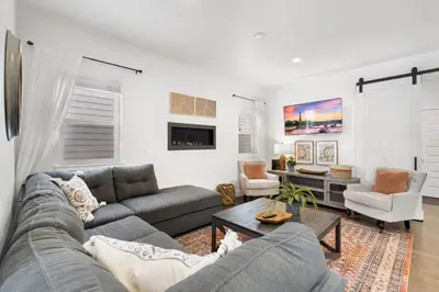 a living room with a couch and a table at Steps from River & Old Town - Hot Tub & King Bed in Fort Collins