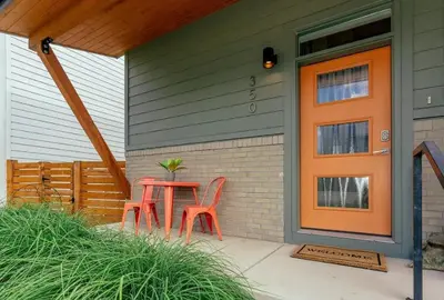 a table and two chairs on the porch of a house at Steps from River & Old Town - Hot Tub & King Bed in Fort Collins