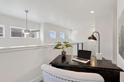 a desk with a laptop computer on it in a room at Steps from River & Old Town - Hot Tub & King Bed in Fort Collins