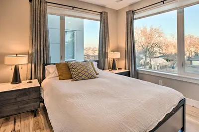 a bedroom with a bed and a large window at Denver Tennyson Townhouse with Rooftop Deck in Denver