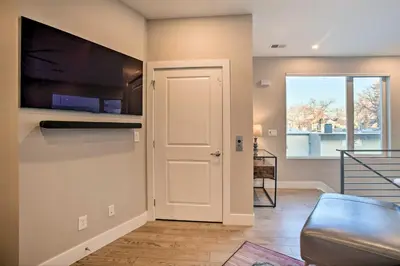 a living room with a television and a door with a window at Denver Tennyson Townhouse with Rooftop Deck in Denver
