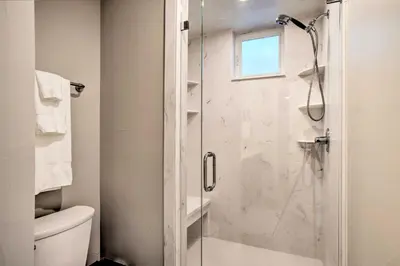 a bathroom with a shower with a glass door at Denver Tennyson Townhouse with Rooftop Deck in Denver