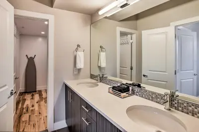 a bathroom with two sinks and a large mirror at Denver Tennyson Townhouse with Rooftop Deck in Denver