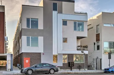 a car parked in front of a building at Denver Tennyson Townhouse with Rooftop Deck in Denver