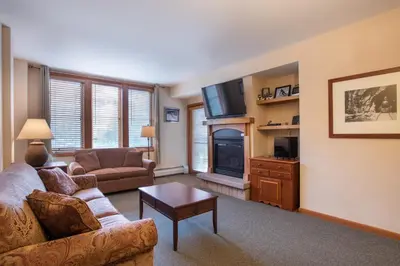 a living room with a couch and a tv at Zephyr Mountain Lodge Value-Rated 2202 in Winter Park