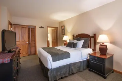 a bedroom with a bed and a flat screen tv at Zephyr Mountain Lodge Value-Rated 2202 in Winter Park