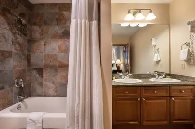 a bathroom with a tub and two sinks at Zephyr Mountain Lodge Value-Rated 2202 in Winter Park