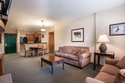 a living room with a couch and a table at Zephyr Mountain Lodge Value-Rated 2202 in Winter Park
