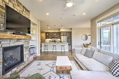 a living room with a couch and a fireplace at Winter Park Condo with Balcony about 4 Mi to Slopes in Winter Park