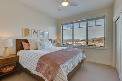 a bedroom with a bed and a large window at Winter Park Condo with Balcony about 4 Mi to Slopes in Winter Park