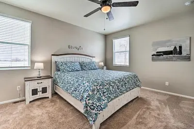 a bedroom with a bed and a ceiling fan at Dreamy Windsor Home with Grill about 3 Miles to Lake! in Windsor