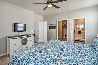 a bedroom with a bed and a flat screen tv at Dreamy Windsor Home with Grill about 3 Miles to Lake! in Windsor