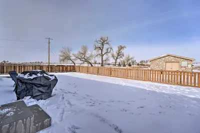 a yard covered in snow with a fence at Dreamy Windsor Home with Grill about 3 Miles to Lake! in Windsor