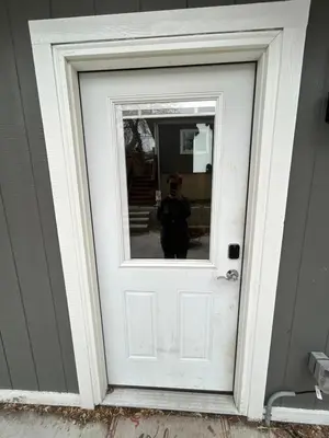a person standing in front of a white door at Basement Unit 2br 2ba in Barnum West Near Belmar and Sloan Lake 10 mins to Downtown in Denver