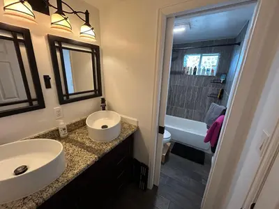 a bathroom with a sink and a toilet and a tub at Basement Unit 2br 2ba in Barnum West Near Belmar and Sloan Lake 10 mins to Downtown in Denver