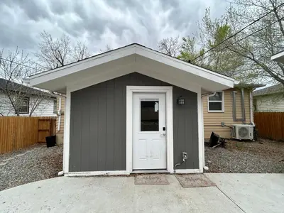 a small garage with a white door in a house at Basement Unit 2br 2ba in Barnum West Near Belmar and Sloan Lake 10 mins to Downtown in Denver