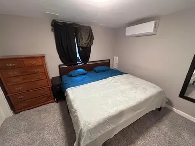 a small bedroom with a bed and a dresser at Basement Unit 2br 2ba in Barnum West Near Belmar and Sloan Lake 10 mins to Downtown in Denver