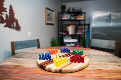 a wooden board with colorful beads on top of a table at The Getaway,Hot Tub, AC, 2miles from RMNP in Estes Park